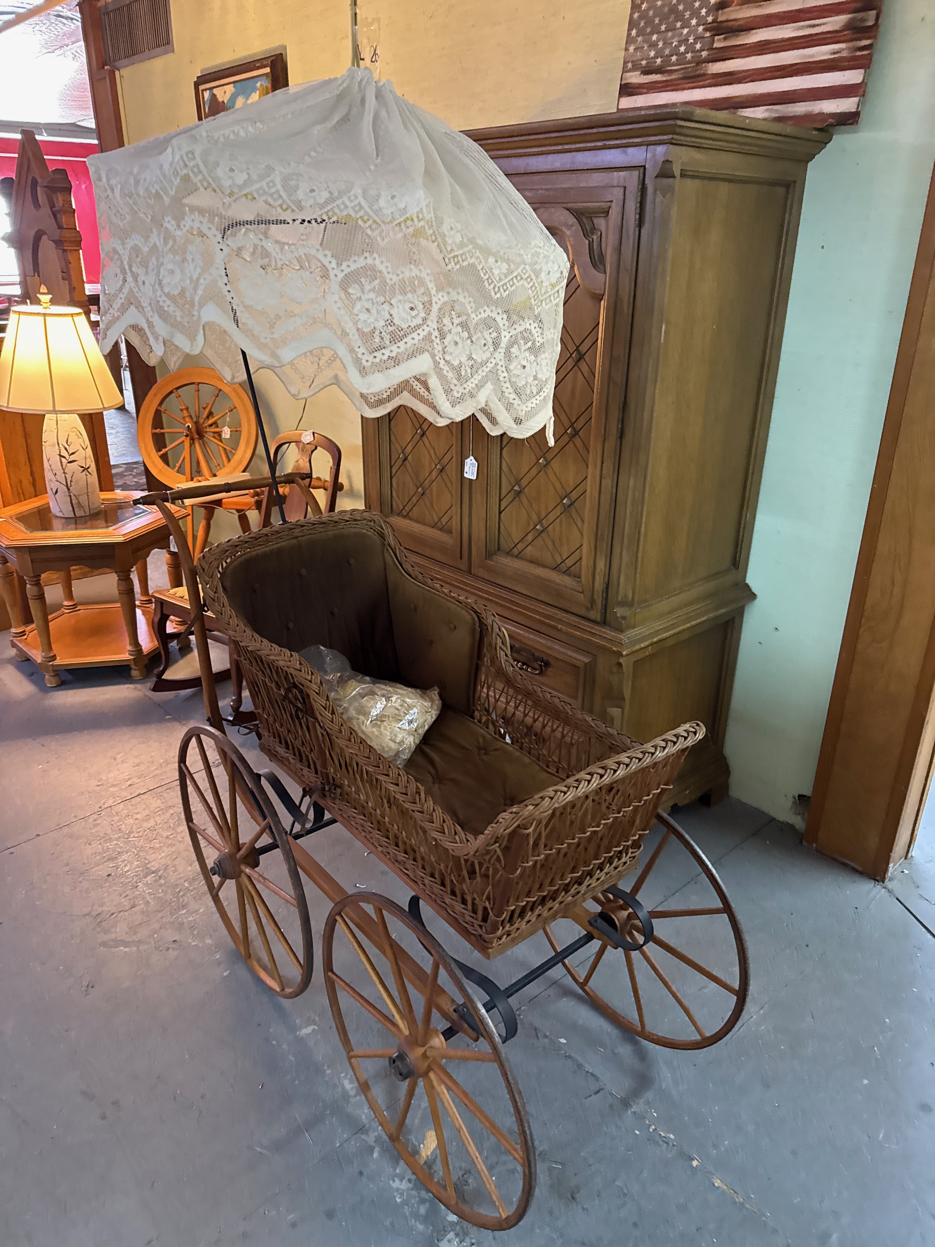 Antique wicker carriage with a lace canopy